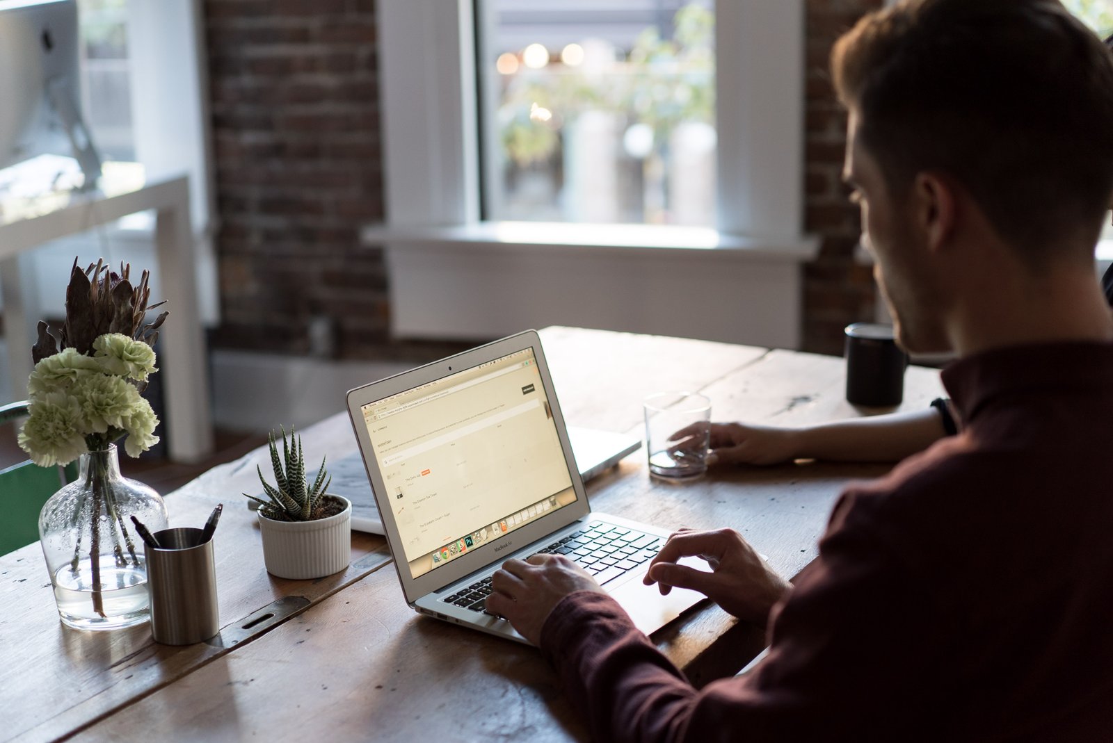 Professional working on a laptop at an office desk, representing freelance and remote work